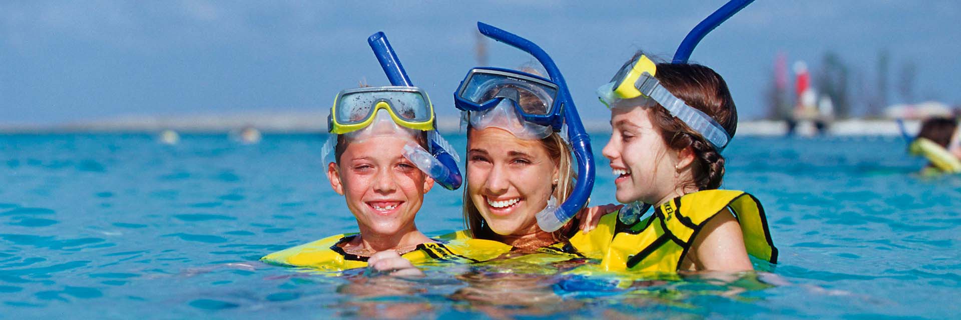 Snorkeling; mom; son; daughter; smiling