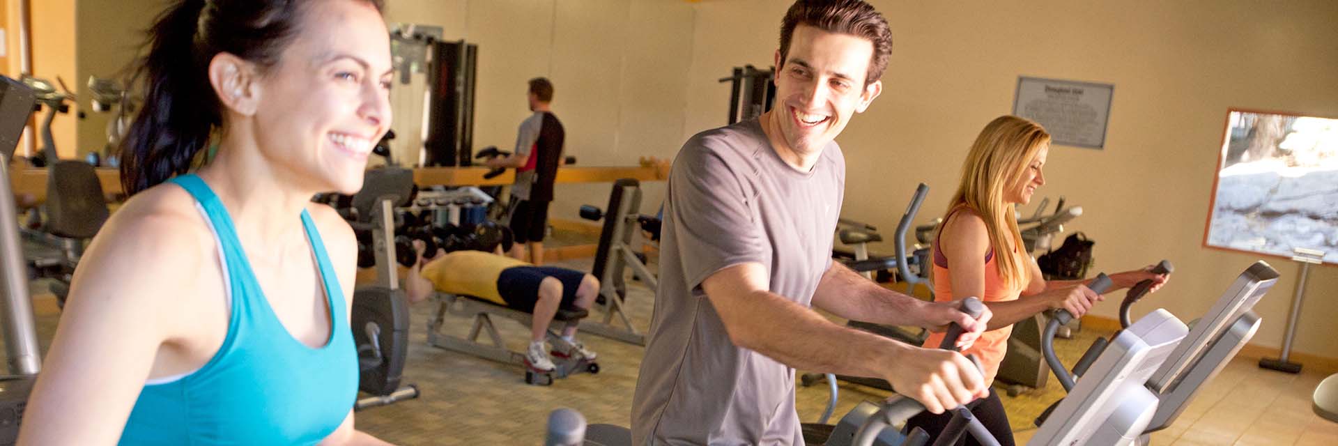 Resort Fitness Center; man; woman smiling and running