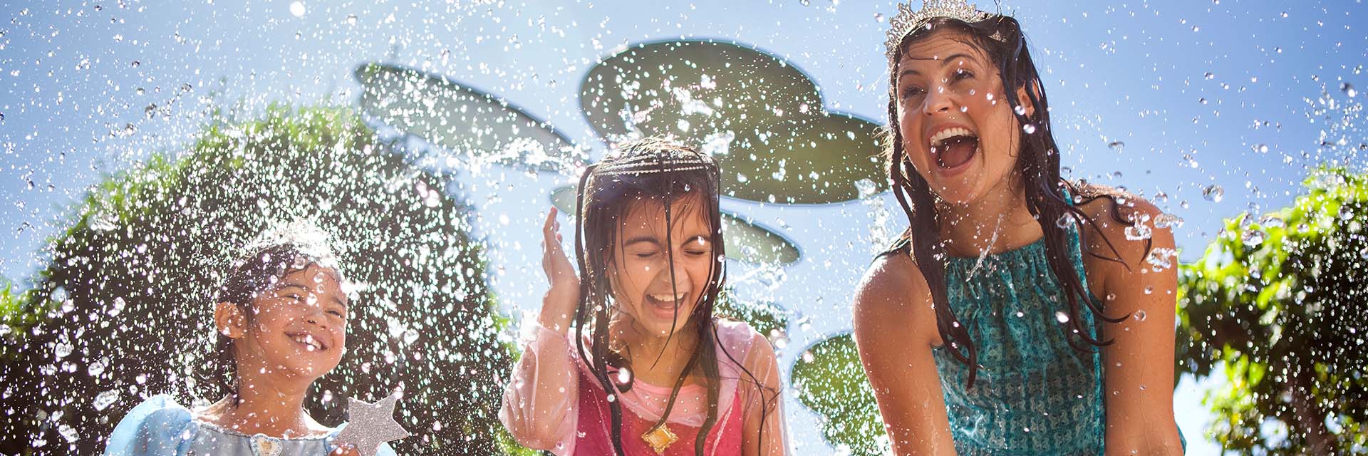 Mom and two daughters splashing at Pool