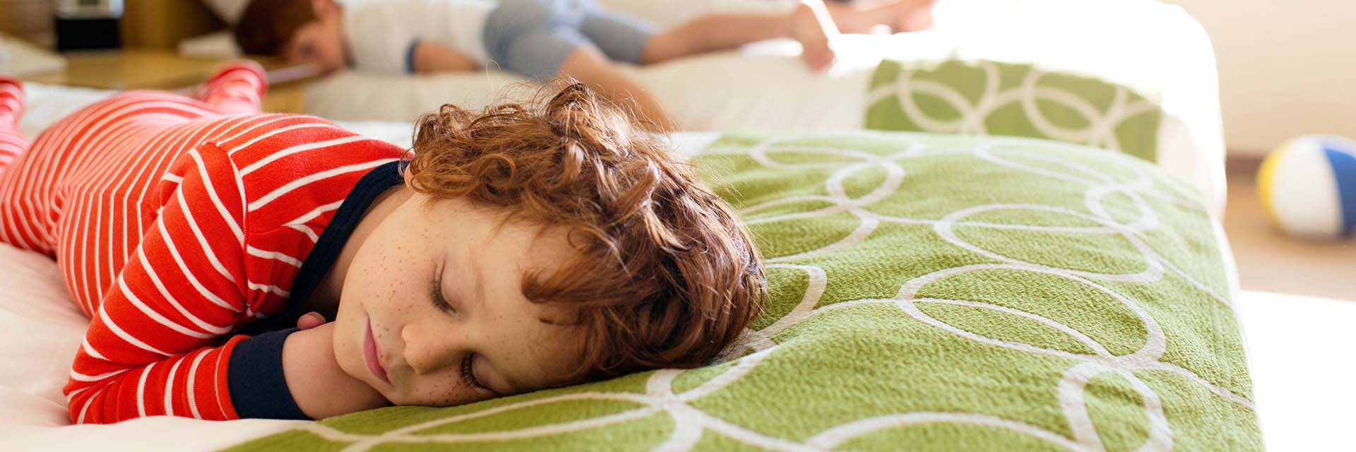Child sleeping on resort bed in pj's