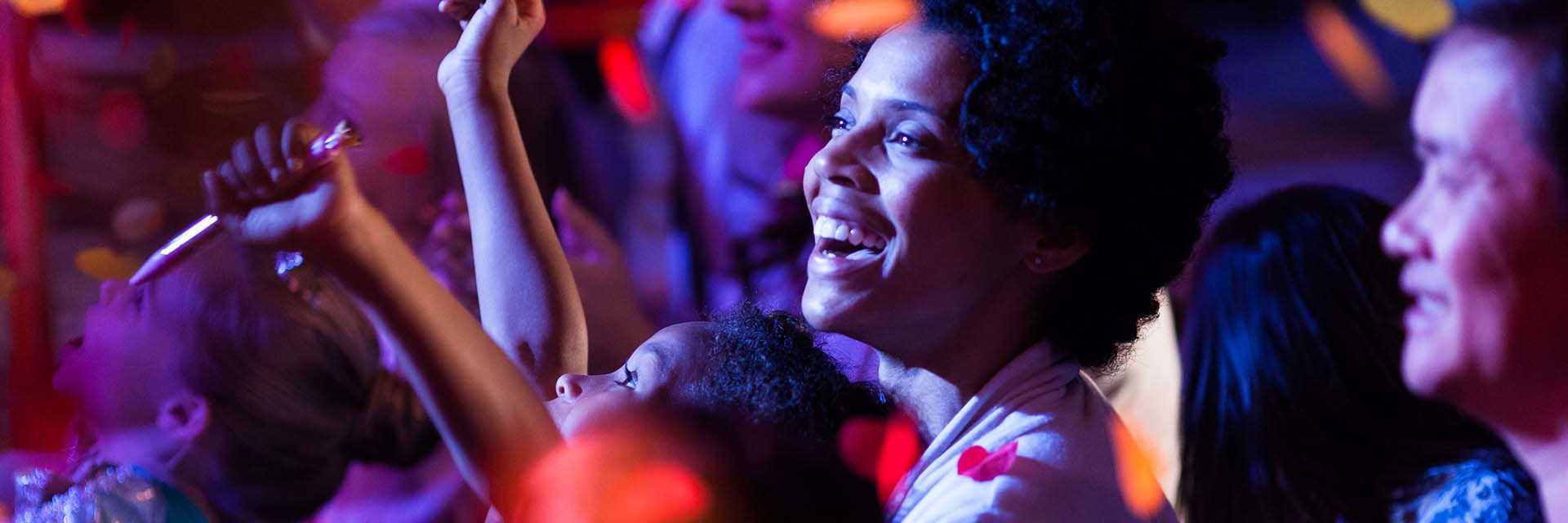 AA Family watching a live show; smiles