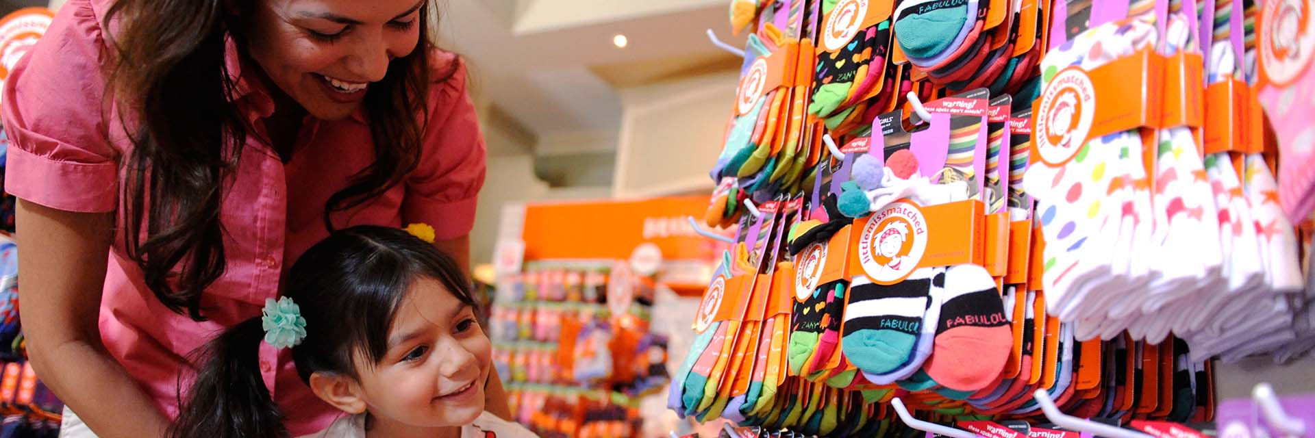 Child and Mom Shopping for socks; downtown disney