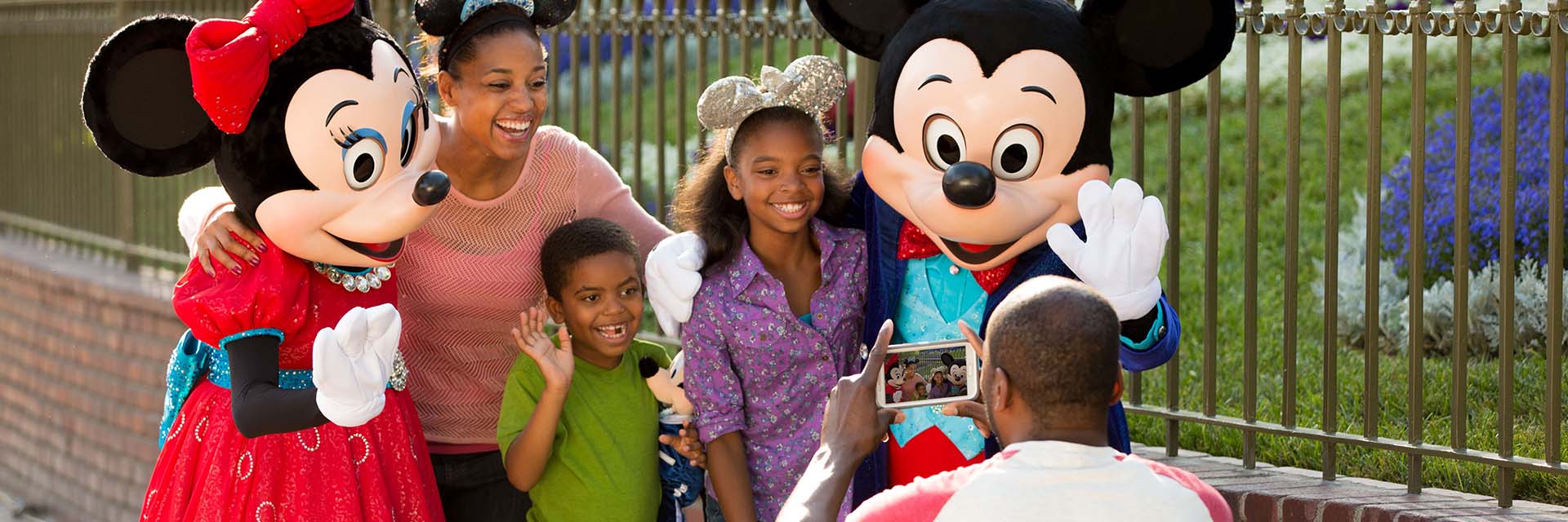Family AA Taking Photo with Mickey and Minnie Mouse