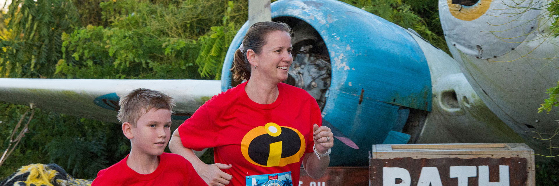 Mom And Son Running through park; RunDisney; incredibles shirt