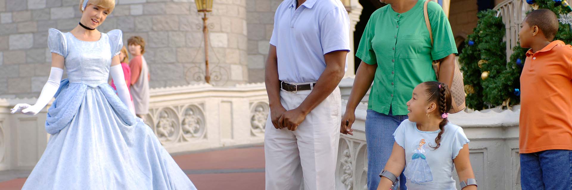 disabled girl with family; AA; Cinderella; Cinderella's Castle: Magic Kingdom; wearing Cinderella shirt