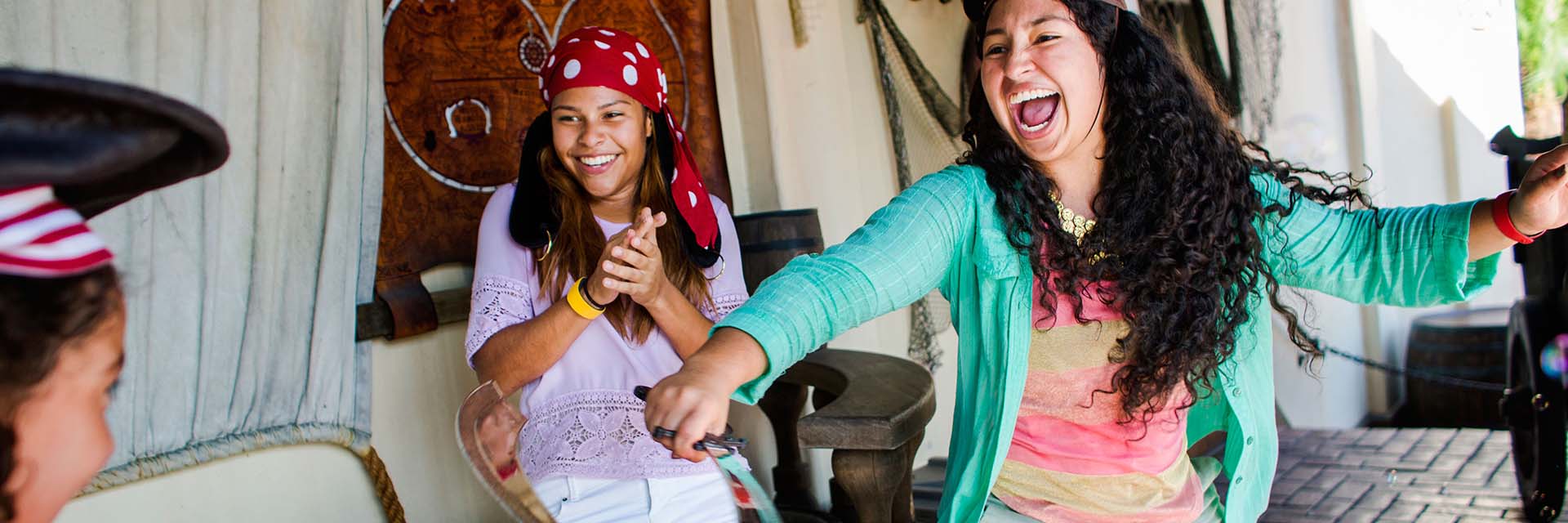 Teens in costume as Pirate Sword fighting