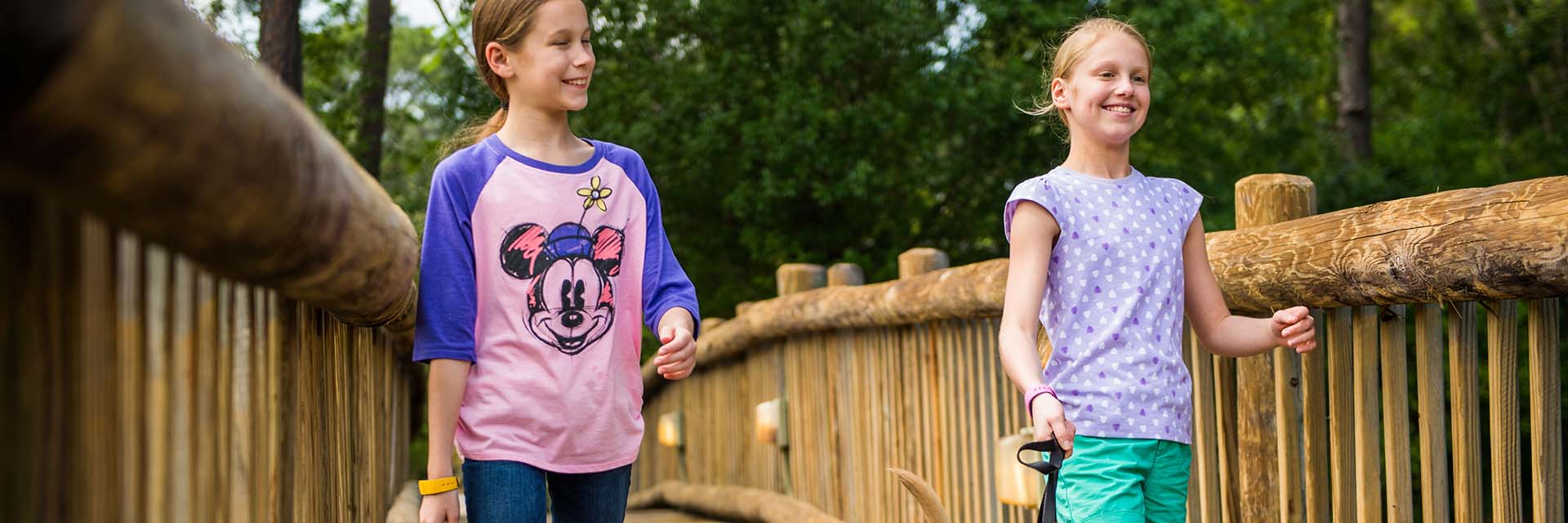 Girls Walking across WDW Bridge; Minnie Mouse Tee Shirt; Sisters; magic band