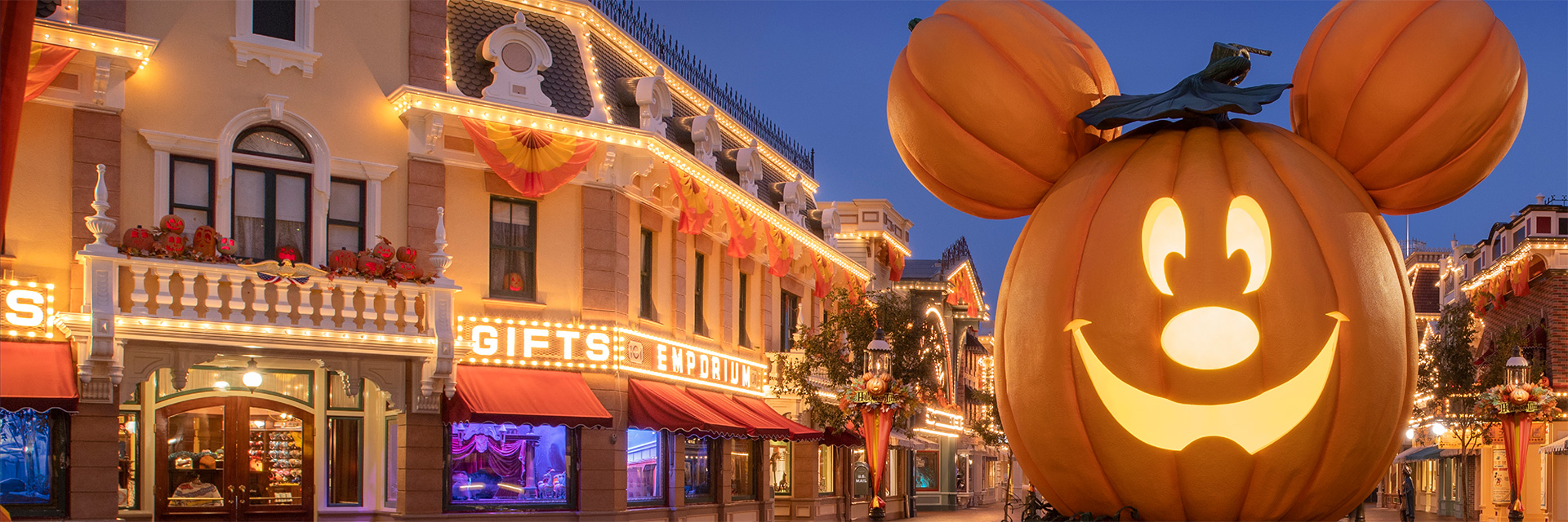 DLR Halloween Header; Photo of a large mickey  jack'o'latern decoration on Main Street; night