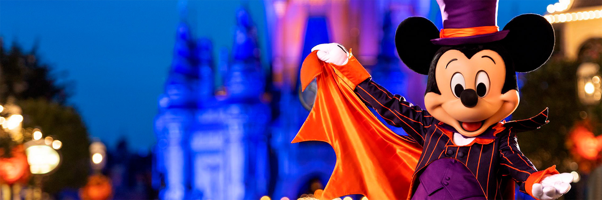 Photo of Mickey Mouse in Halloween costume on Main Street at dusk